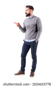 Confident Young Business Man With Documents Pointing Finger At Copyspace. Full Body Length Portrait Isolated On White Studio Background.