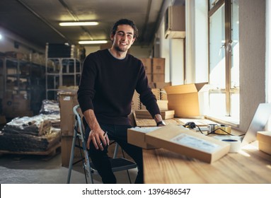Confident young businessman working at online business store. Small business owner at his work desk. - Shutterstock ID 1396486547
