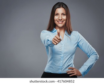 Confident young businesswoman giving the thumbs up against a gray background - Powered by Shutterstock - Get 15% off with code: PIKWIZARD15
