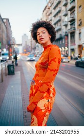 Confident Young Curly Black Woman Standing Outdoor City Posing Looking Camera Strong And Proud