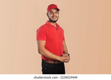 Confident young delivery man standing isolated on Color Background