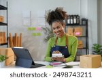 Confident young entrepreneur manages her online business in a bright office, handling shipping and finances with ease