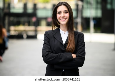 Confident young female manager outdoor in a modern urban setting - Shutterstock ID 2056941161