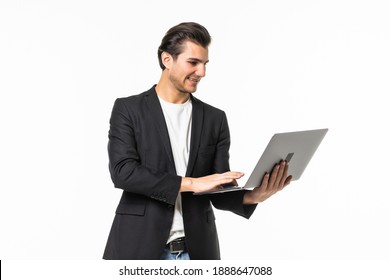 Confident young handsome man in shirt and tie working on laptop while standing against white background