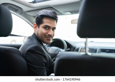 Confident young Hispanic businessman traveling in car - Shutterstock ID 1764190946