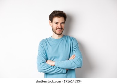 Confident Young Man With Beard, Cross Arms On Chest And Smile At Camera, Standing Like Professional Over White Background