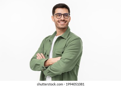 Confident young man in casual green shirt looking away, standing with crossed arms isolated on gray  - Powered by Shutterstock