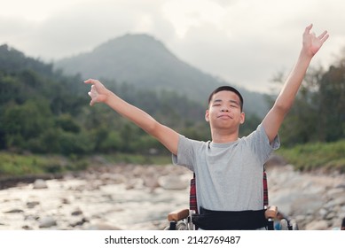 Confident Young Man With A Disability With Smiley Face On Nature Background, Relaxing, Playing, Learning And Exercise In The Outdoor On Vacation With Family, Natural Therapy And Mental Health Concept.