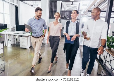 Confident Young Multiethnic Business People Walking Together In Office