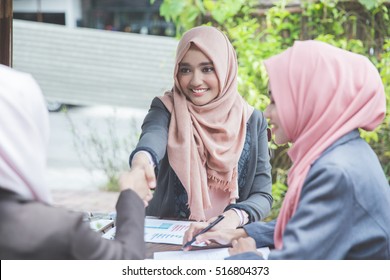 Confident Young Muslim Business Woman Shaking Hands. Teamwork Deal Concept