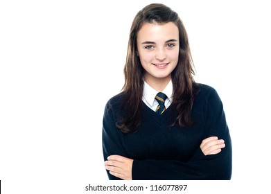 Confident Young School Child In Uniform Posing With Folded Arms