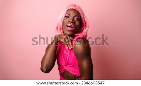 Confident Young Transgender Woman's Joyful Portrait on pink background