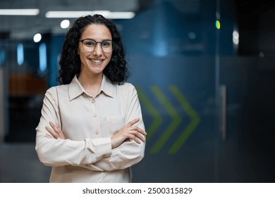 Confident young woman with glasses smiling in modern office setting. Professional attire , positive demeanor reflect success and enthusiasm in workplace. Inspiration for career business motivation. - Powered by Shutterstock