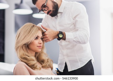 Confident young woman is looking at her reflection - Powered by Shutterstock