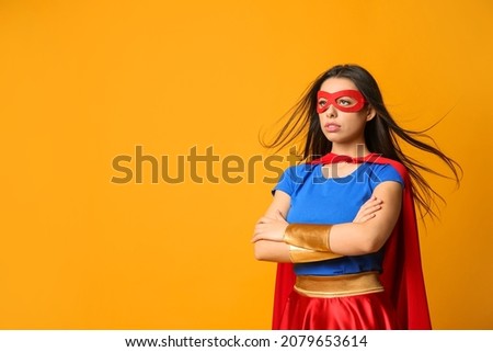 Confident young woman wearing superhero costume on orange background, space for text ストックフォト © 