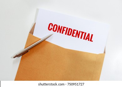 Confidential Document In Envelope With Pen On Desk