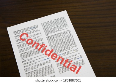 Confidential Document On Wooden 
Desk