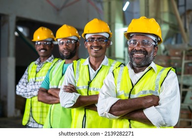 Confidently standing industrial workers with arms crossed by looking at camera - concept of workforce, occupation and safety - Shutterstock ID 2139282271