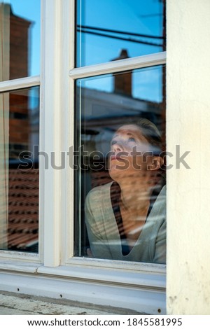 Similar – Foto Bild neugieriger Typ schaut durchs Fenster.