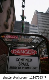 Confined Space Sign Equipped With Industrial Stand By Manhole Fall Arrest Tripot Vertical Safety Rescue Equipment On Construction Building Site Downtown Sydney City CBD, Australia 
