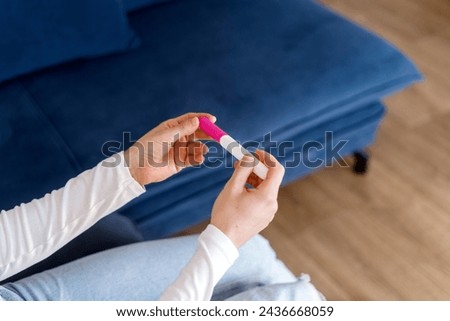 Confirmed results of successful artificial insemination. Ivf concepts. High angle, close up view of woman hands with home pregnancy test. Female meeting good news about gestation, awaited maternity Stock photo © 
