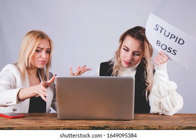 Conflict Between Boss And Employee. Stressed Female Worker Holding Sign Stupid Boss.