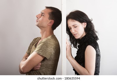 Conflict Between Man And Woman Standing On Either Side Of A Door