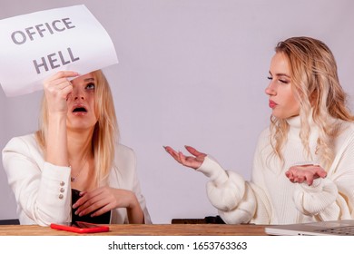 Conflict Between Two Female Manager Colleagues. Portrait Of Young Employee Holding Sign Office Hell. 