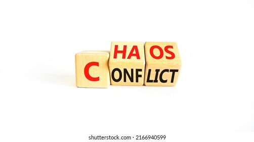 From conflict to chaos symbol. Concept words Conflict and Chaos on wooden cubes. Beautiful white table white background. Businessman hand. Business Conflict and Chaos concept. Copy space.