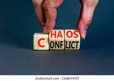 From conflict to chaos symbol. Concept words Conflict and Chaos on wooden cubes. Businessman hand. Beautiful grey background. Businessman hand. Business Conflict and Chaos concept. Copy space.