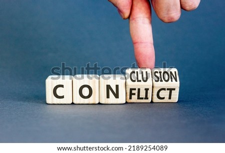 Conflict or conclusion symbol. Businessman turns wooden cubes, changes the word 'conflict' to 'conclusion'. Beautiful grey background, copy space. Business, conflict or conclusion concept.