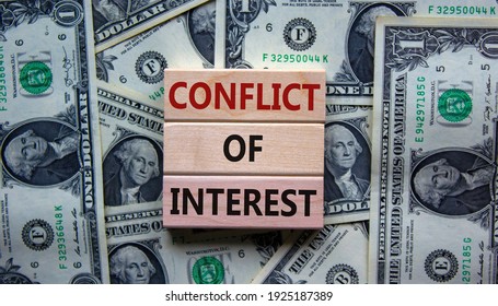 Conflict of interest symbol. Wooden blocks with words 'conflict of interest'. Beautiful background from dollar bills. Copy space. Business and conflict of interest concept. - Shutterstock ID 1925187389