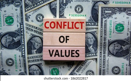 Conflict of values. Wooden blocks with words 'conflict of values'. Beautiful background from dollar bills. Copy space. Business and conflict of values concept. - Shutterstock ID 1862022817