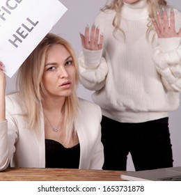 Conflicts Of Office As Risk For Business. Female Worker Holds Sign OFFICE HELL.