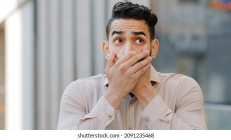 Confused Afraid Scared Young Guilty Man Shocked Surprised Guy Male Hispanic Arab Indian Covers Mouth With Hands Worried About Telling Secret Feels Shock Bad News Looking At Camera, Problem Concept