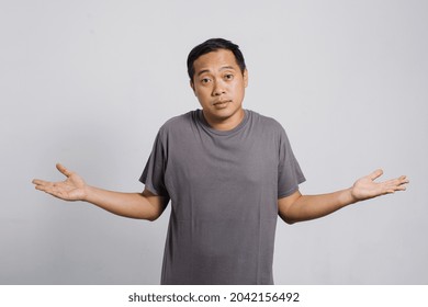 Confused Asian Man By Difficult Question Or No Idea With Helpless Gesture