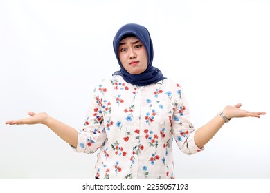 Confused asian muslim woman standing while showing unsure hand gesture. Isolated on white background - Shutterstock ID 2255057193