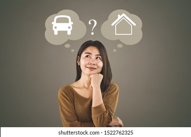 confused Asian woman buyer choosing between buying new home or car