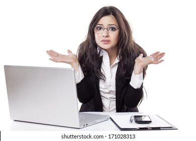 Confused And Beautiful Young Business Woman At The Desk With A Laptop