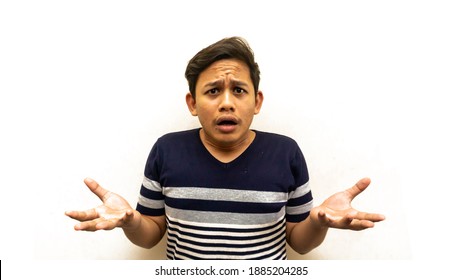Confused and bewildered face expression with open mouth of young Asian Malay man with strips t-shirt with isolated white background. Confuse hand gesture.