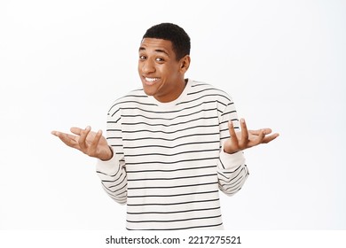 Confused Black Guy Shrugs Shoulders And Looking Clueless, White Background