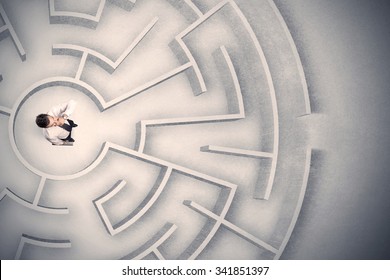Confused business man trapped in a circular maze - Shutterstock ID 341851397