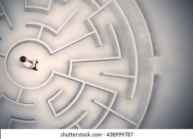 Confused business man trapped in a circular maze - Shutterstock ID 438999787