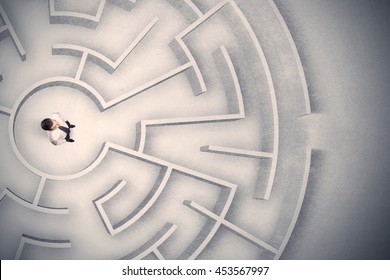Confused business man trapped in a circular maze - Shutterstock ID 453567997