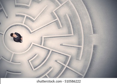 Confused business man trapped in a circular maze - Shutterstock ID 510586222