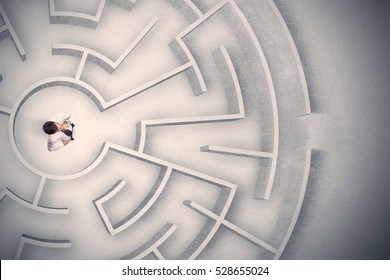 Confused business man trapped in a circular maze