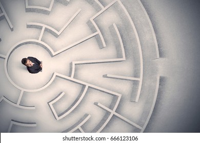Confused business man trapped in a circular maze - Shutterstock ID 666123106