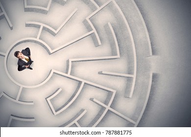 Confused business man trapped in a circular maze - Shutterstock ID 787881775