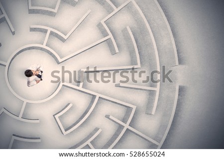 Confused business man trapped in a circular maze