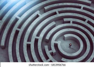 Confused businessman thinks how to find the right way to exit from a big maze - Shutterstock ID 1813906766